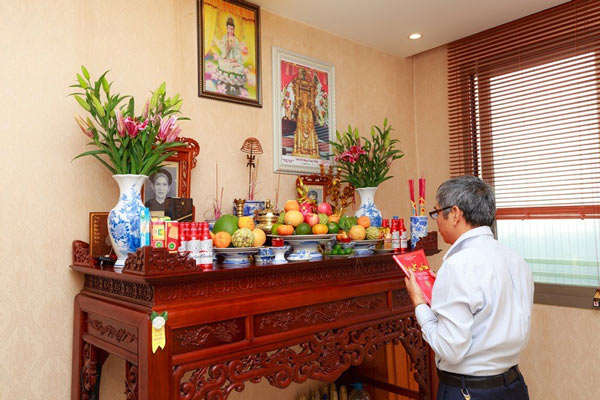Gia chủ trong gia đình thắp hương và đọc văn khấn